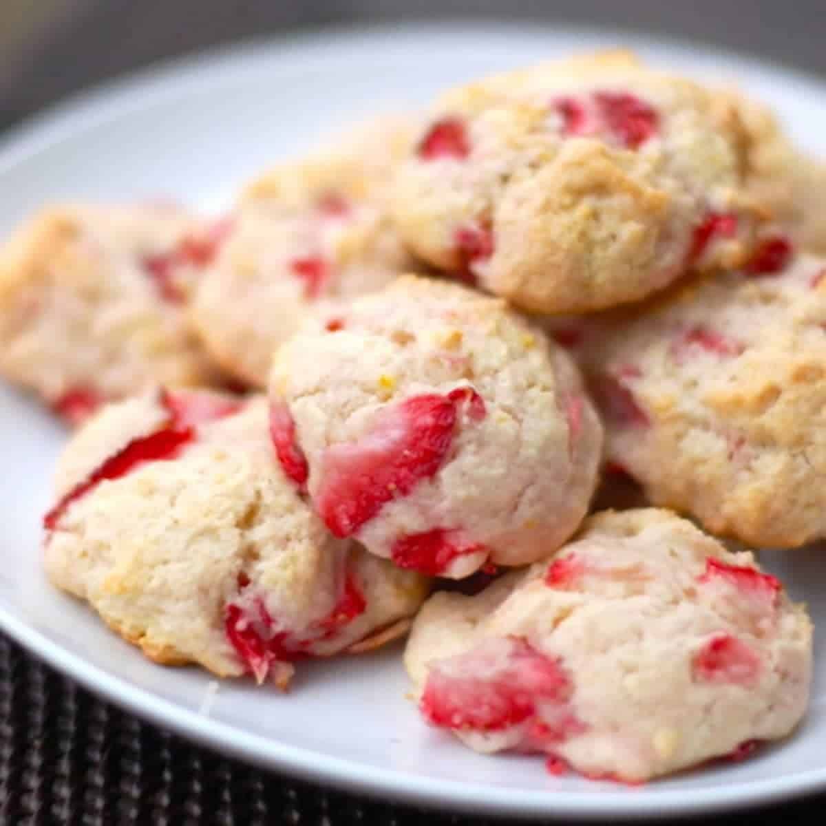 Orangeberry shortcake cookies stacked on a white plate.