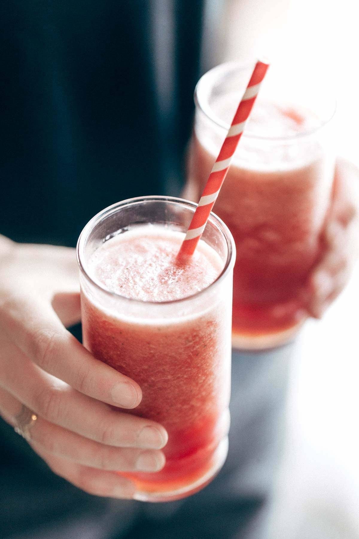 Two smoothies with a straw.